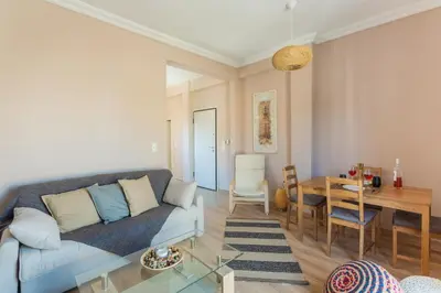 a living room with a couch and a table at 100m2 Luxury Apartment in the Heart of Athens - Living Stone Emerald in Athens