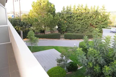 a view of a garden from the balcony of a house at Hotel Pantheon in Markopoulo