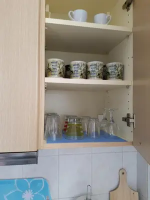 a cupboard filled with lots of cups and dishes at Filopappou Hill Apartment in Athens