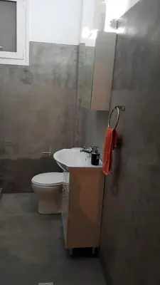 a bathroom with a sink and a toilet at Filopappou Hill Apartment in Athens
