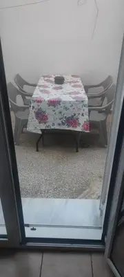 a table with a table cloth on it with chairs at Filopappou Hill Apartment in Athens
