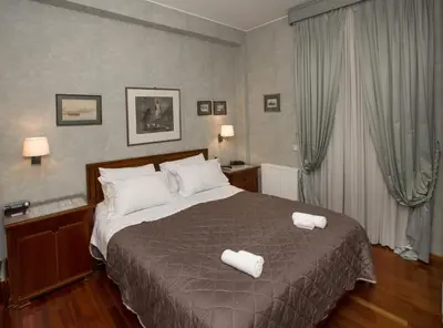 a bedroom with a bed with two white towels on it at Exceptional Villa in Voula near the sea in Athens