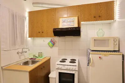 a small kitchen with a sink and a microwave at Kleisthenes' apartment in Athens