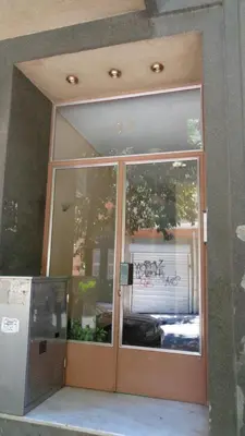 a glass door of a building with writing on it at Kleisthenes' apartment in Athens