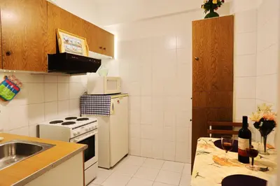a kitchen with a sink and a white refrigerator at Kleisthenes' apartment in Athens