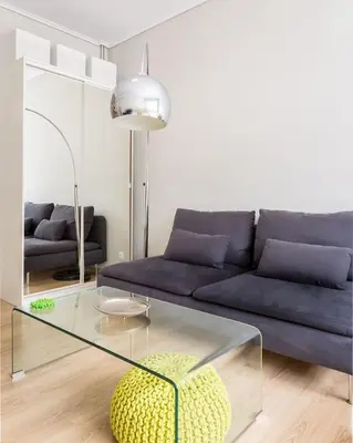 a living room with a couch and a glass table at Stay like a local next to Acropolis & Plaka! in Athens