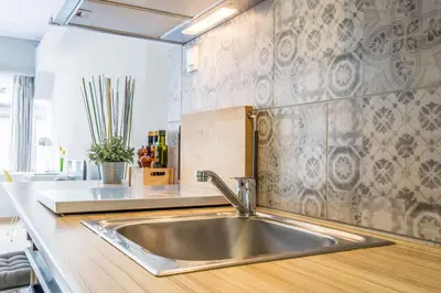 a kitchen with a stainless steel sink in a kitchen at Stay like a local next to Acropolis & Plaka! in Athens