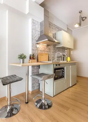 a kitchen with a counter and two bar stools at Stay like a local next to Acropolis & Plaka! in Athens