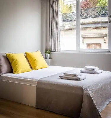 a bed with towels on it in a room with a window at Stay like a local next to Acropolis & Plaka! in Athens