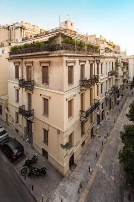 an apartment building with a car parked in front of it at Treat yourself w. this central City-break studio! in Athens