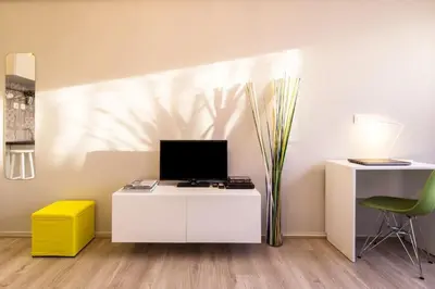 a room with a white desk with a monitor and a chair at Treat yourself w. this central City-break studio! in Athens