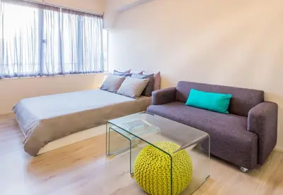 a living room with a bed and a couch at Treat yourself w. this central City-break studio! in Athens