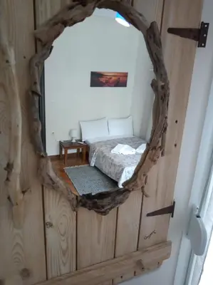 a mirror in a room with a bed in it at Afrodite's apartment (close to Athens city center) in Athens