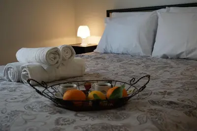 a basket of fruit on a bed with towels at Afrodite's apartment (close to Athens city center) in Athens