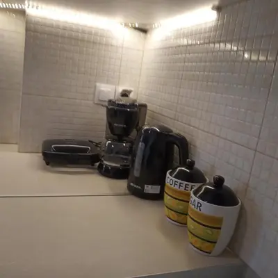 a kitchen counter with two coffee pots on a counter at Afrodite's apartment (close to Athens city center) in Athens