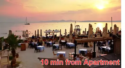 a view of a restaurant on the beach at sunset at Afrodite's apartment (close to Athens city center) in Athens