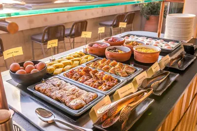 a buffet with many different types of food on a table at Niche Hotel Athens in Athens