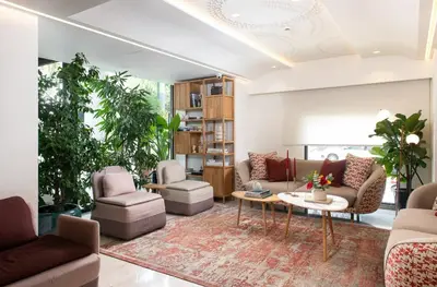 a living room with couches and a table at Niche Hotel Athens in Athens