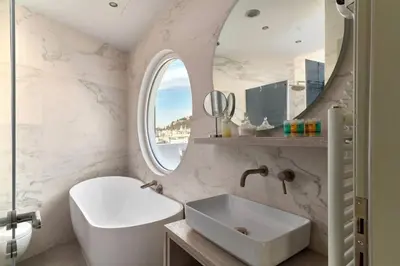 a white bathroom with a sink and a mirror at Acropolis Junior Suite in Athens