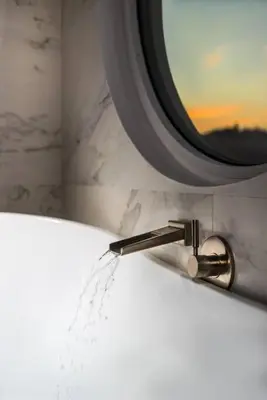 a bathroom sink with water coming out of a faucet at Acropolis Junior Suite in Athens