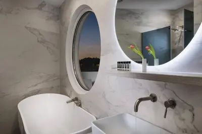 a bathroom with a sink and a mirror at Acropolis Junior Suite in Athens