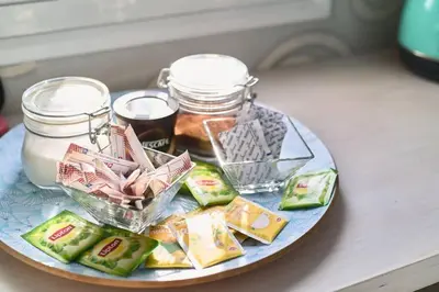 a plate with snacks and a jar of honey on a counter at Acropolis Junior Suite in Athens