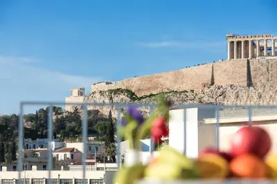 a view of the ruins of the acropolis from a city at Acropolis Junior Suite in Athens