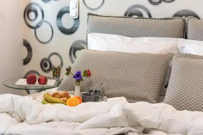 a bed with a tray of fruit on it at Acropolis Junior Suite in Athens