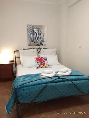 a bed with two towels on it in a bedroom at Romantic and cosy apartment in Athens