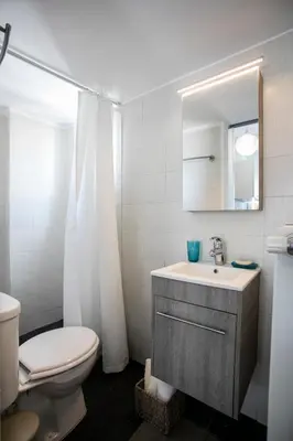 a bathroom with a sink and a toilet and a mirror at Romantic and cosy apartment in Athens