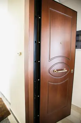a wooden door with a handle in a room at Romantic and cosy apartment in Athens