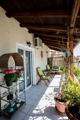 a patio with flowers and plants on a house at Romantic and cosy apartment in Athens