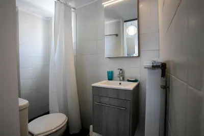 a bathroom with a sink and a toilet and a mirror at Romantic and cosy apartment in Athens