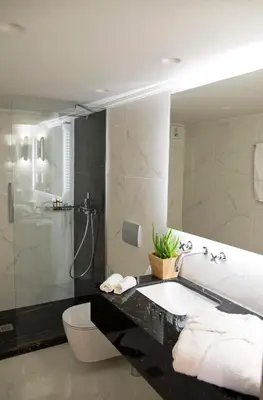 a bathroom with a shower and a toilet and a mirror at Four Streets Athens - Luxury Suites Apartments in Athens in Athens
