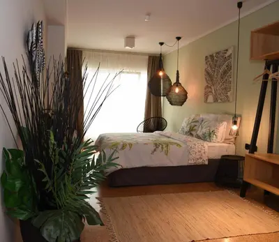 a bedroom with a bed and a potted plant at CasaGreek Monastiraki - Athens in Athens