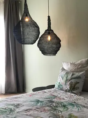 two lights hanging over a bed in a bedroom at CasaGreek Monastiraki - Athens in Athens