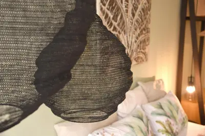 a blanket hanging over a couch in a bedroom at CasaGreek Monastiraki - Athens in Athens