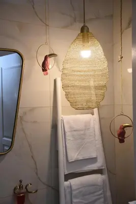a bathroom with a towel rack and a pendant light at CasaGreek Monastiraki - Athens in Athens