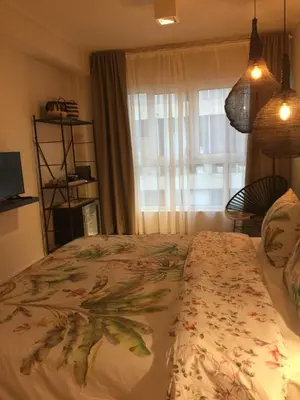 a bedroom with a bed with a floral bedspread at CasaGreek Monastiraki - Athens in Athens