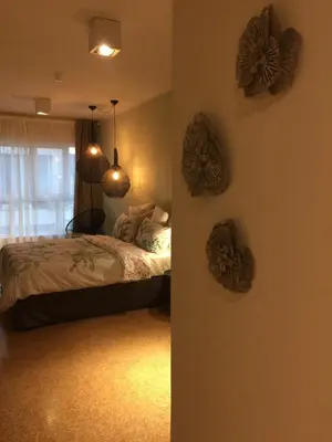 a bedroom with a bed and two decorations on the wall at CasaGreek Monastiraki - Athens in Athens