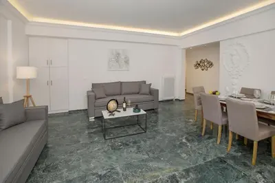 a living room with a couch and a table at Roomy and comfortable apartment near Acropolis by GHH in Athens