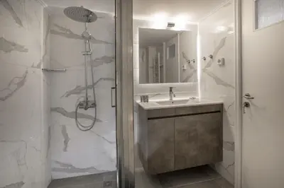 a bathroom with a shower and a sink at Roomy and comfortable apartment near Acropolis by GHH in Athens
