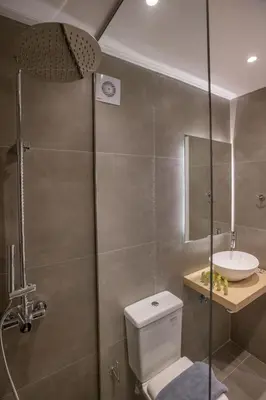 a bathroom with a shower and a toilet and a sink at Roomy and comfortable apartment near Acropolis by GHH in Athens