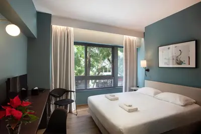 a hotel room with a bed and a window at Athens21 in Athens