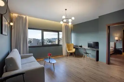 a living room with a couch and a table and a desk at Athens21 in Athens
