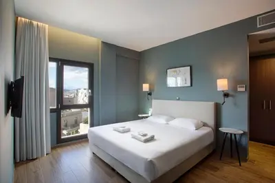 a bedroom with a large bed and a large window at Athens21 in Athens