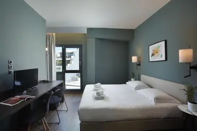 a bedroom with a bed and a desk with a computer at Athens21 in Athens
