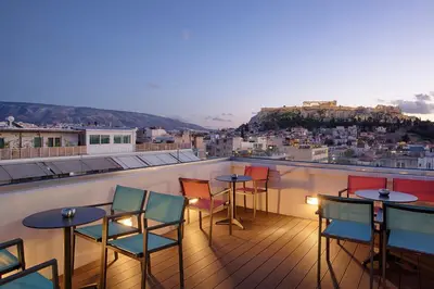 a balcony with tables and chairs and a view at Athens21 in Athens