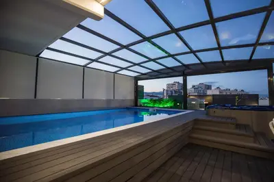 a swimming pool with a view of a building at Zambelis Athens Penthouse Spa in Athens