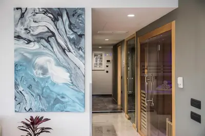a hallway with a painting on the wall at Zambelis Athens Penthouse Spa in Athens